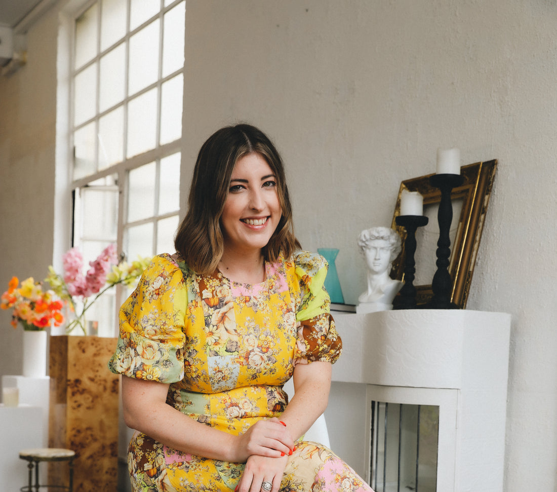 image of Self Bloom Co founder Kymberly Louise wearing a yellow floral dress