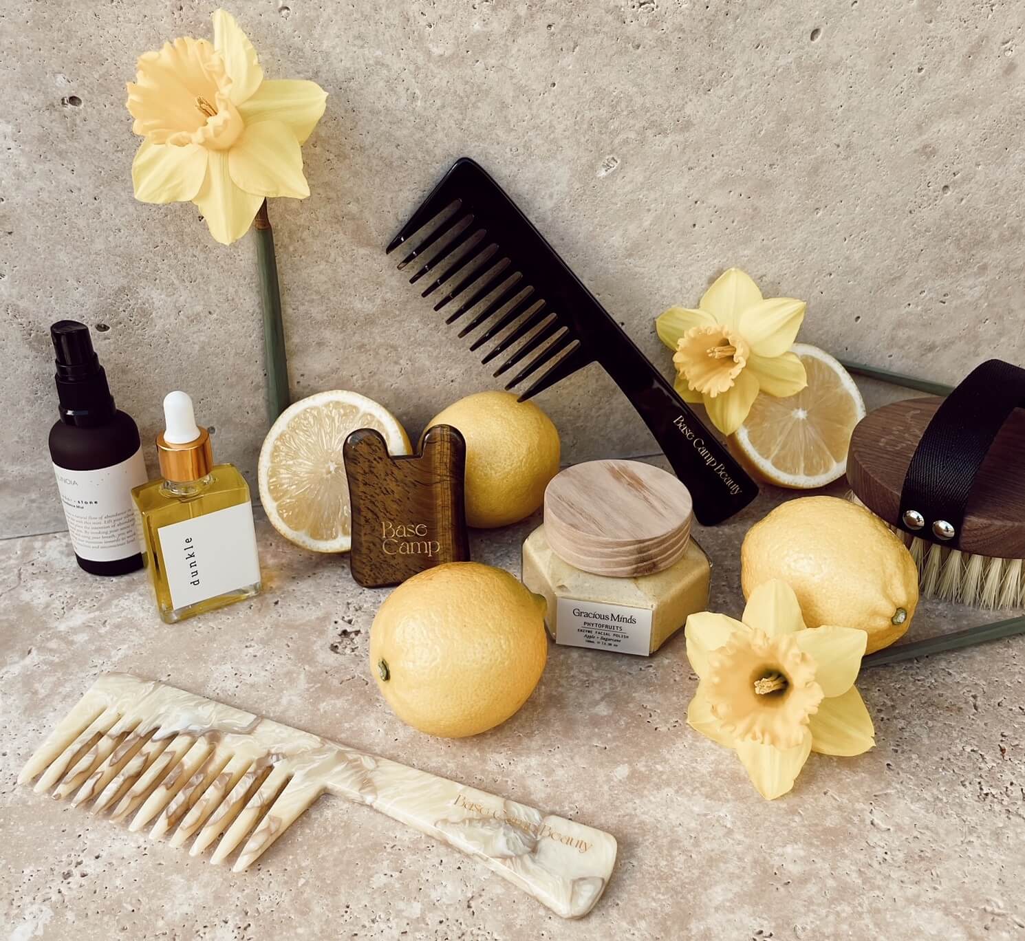 A selection of Self Bloom self-care products to create your own self care rituals. Self-care essentials are beautifully styled with yellow daffodils and lemons.