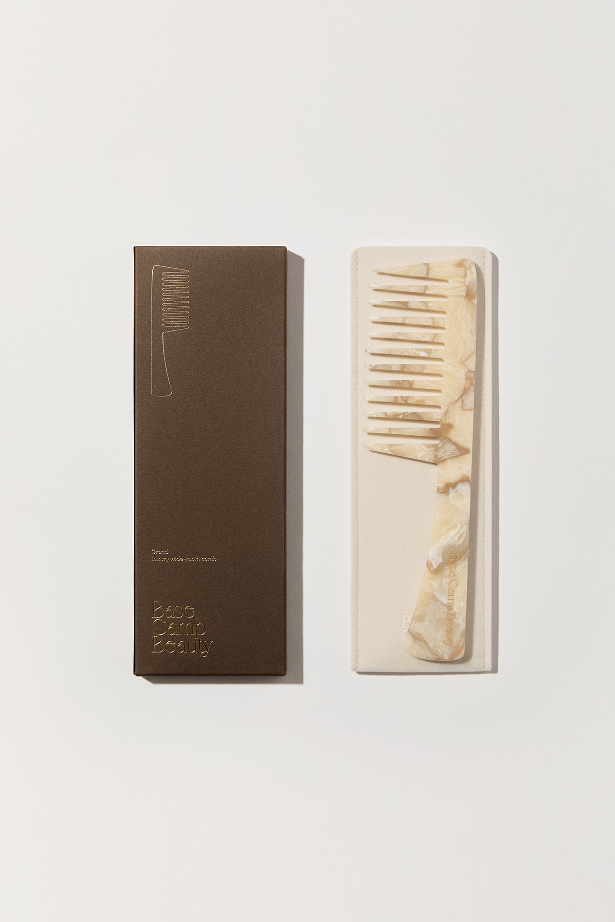 Flatlay of Base Camp Beauty Comb in colour buttermilk with storage sleeve and box.